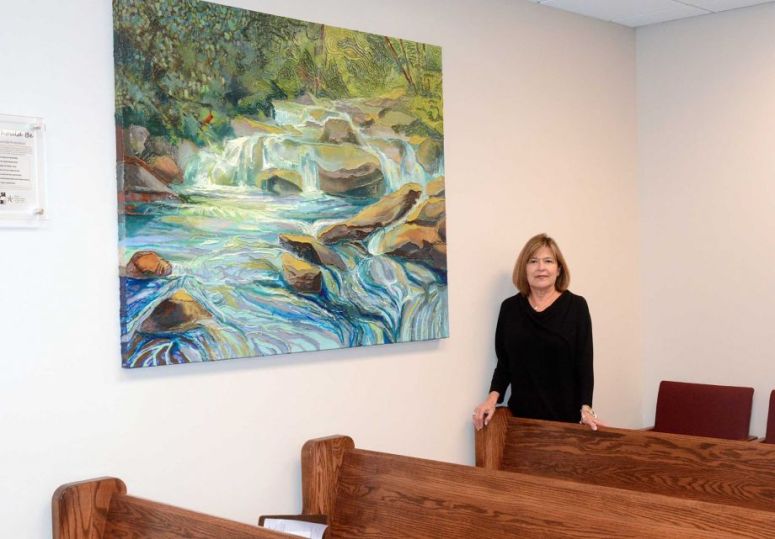 Judge Mary Ann Turner stands by a painting painted by juveniles at the MoCo Juvenile Justice Center in her County Court at Law #4 courtroom, 210 W. Davis Street in downtown Conroe. 